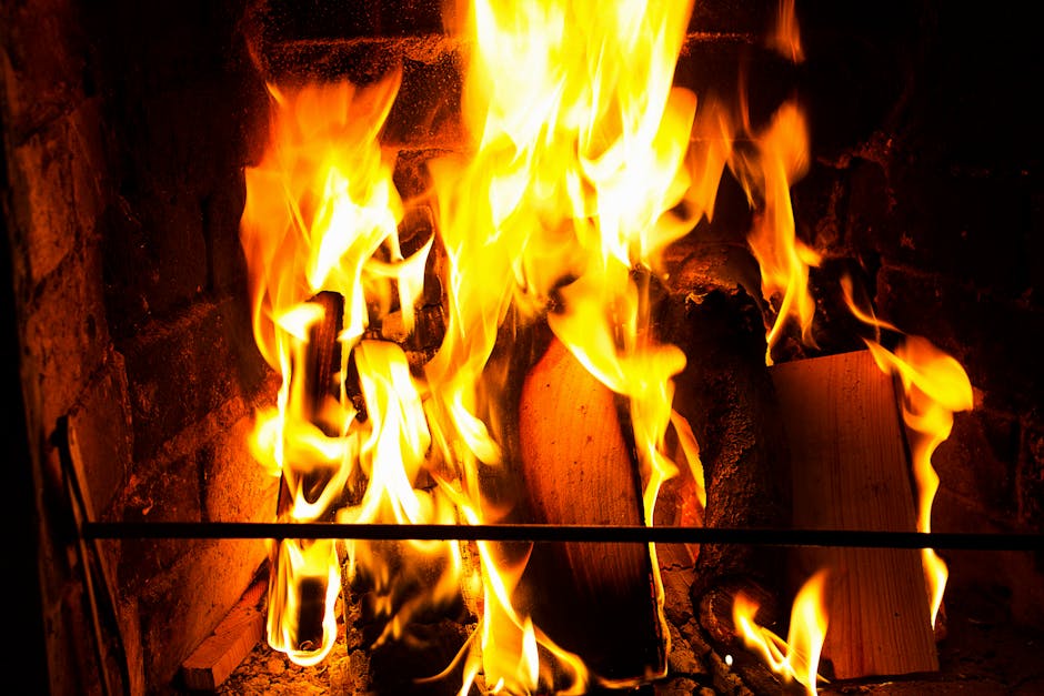 Bright flames consuming firewood in a brick fireplace