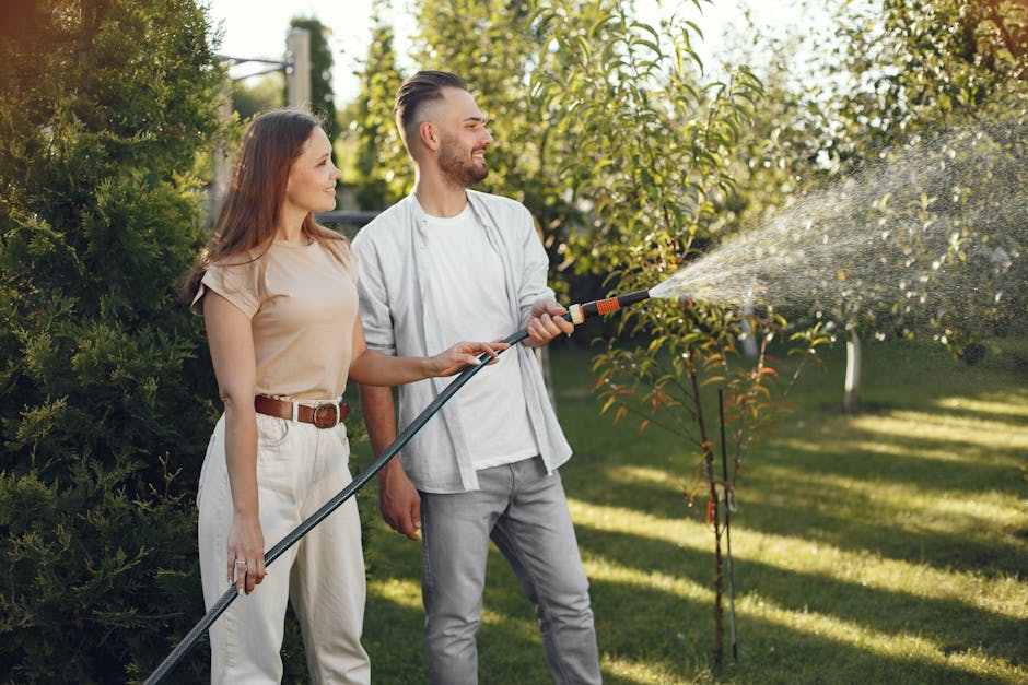 Couple working together to water their garden in a backyard setting